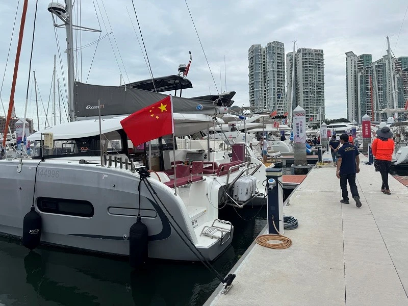 Visitors view the yachts at the booth