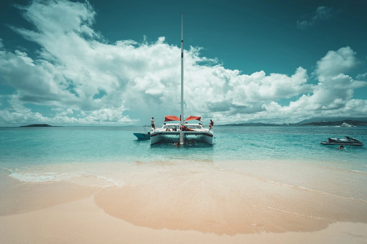 Sailing catamaran stays in beach waters