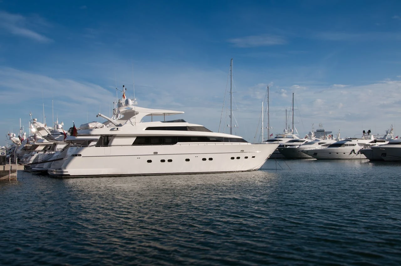 White yachts docked at the marina