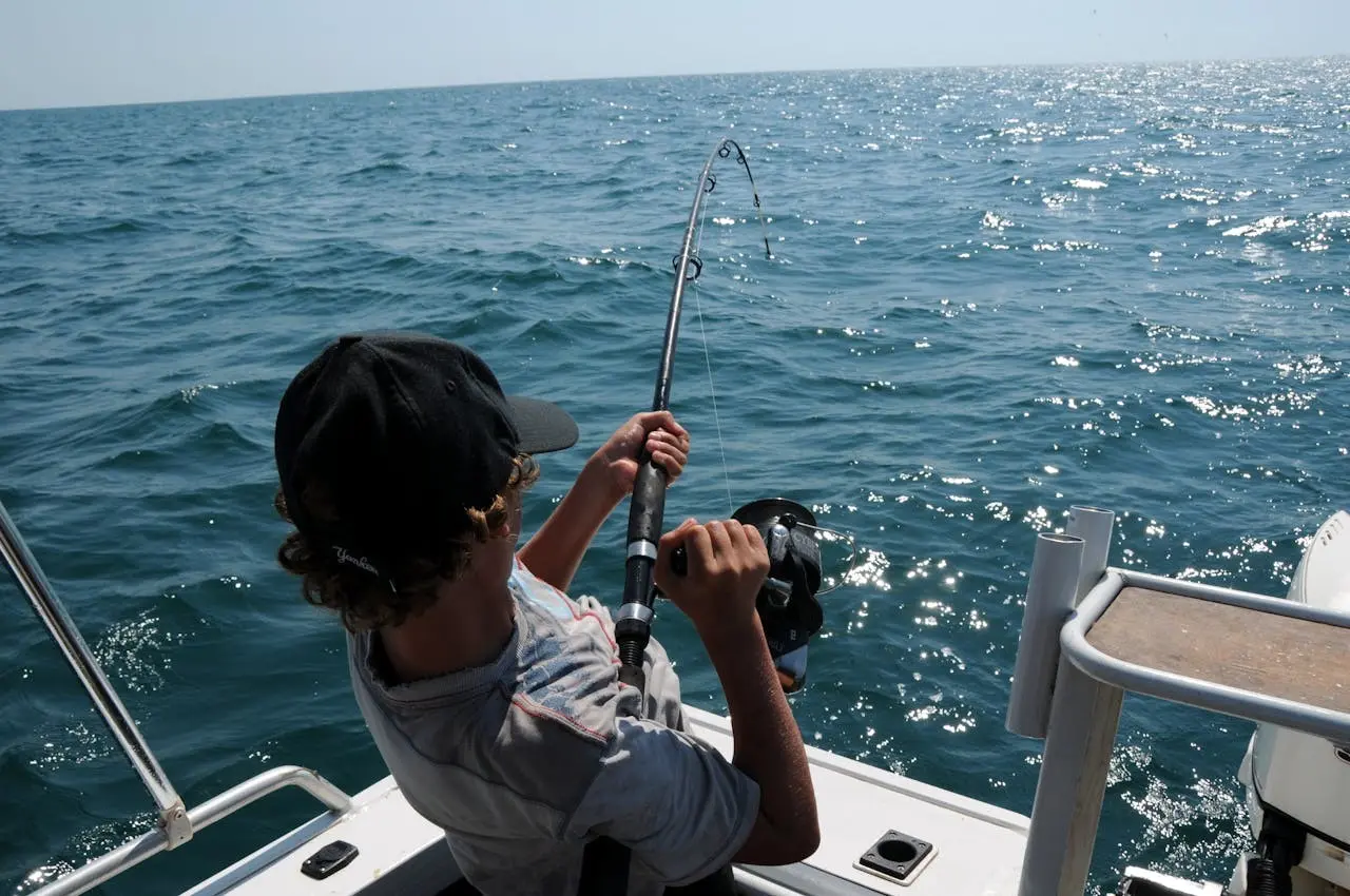 A man fishing on a sailing yacht